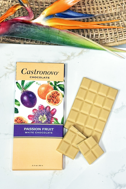 Castronovo passion fruit white chocolate bar with packaging on a marble surface.
