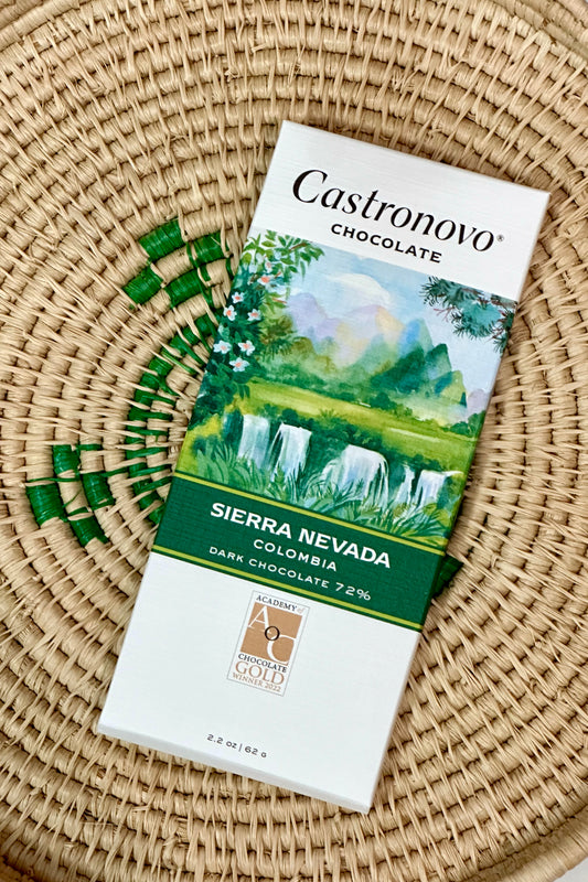 A bar of Castronovo Chocolate with a Sierra Nevada theme, featuring an illustration of a lush green landscape on the packaging.