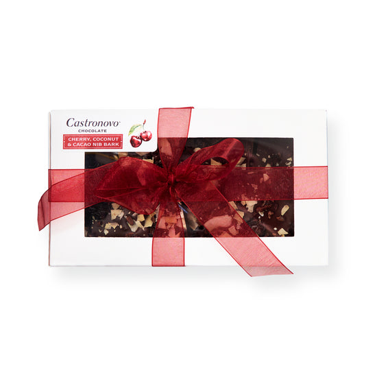 Castronovo brand cherry, coconut, and cacao nib bark. In white box with product visible, wrapped in red ribbon 