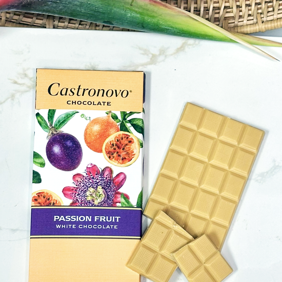 Castronovo passion fruit white chocolate bar with packaging on a marble surface.