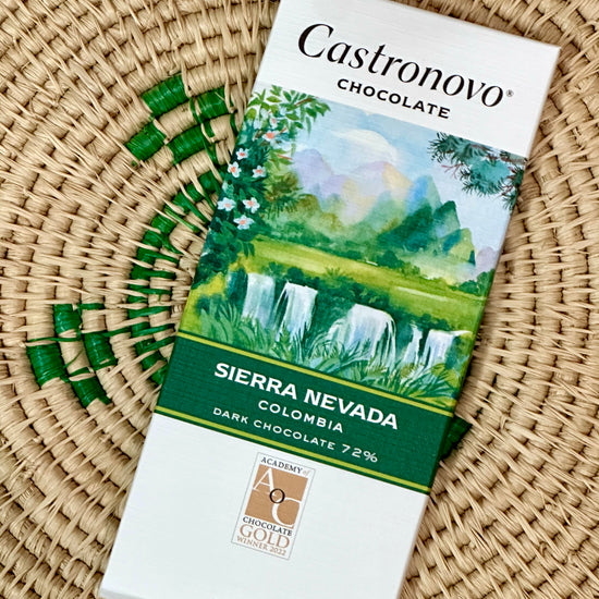 A bar of Castronovo Chocolate with a Sierra Nevada theme, featuring an illustration of a lush green landscape on the packaging.