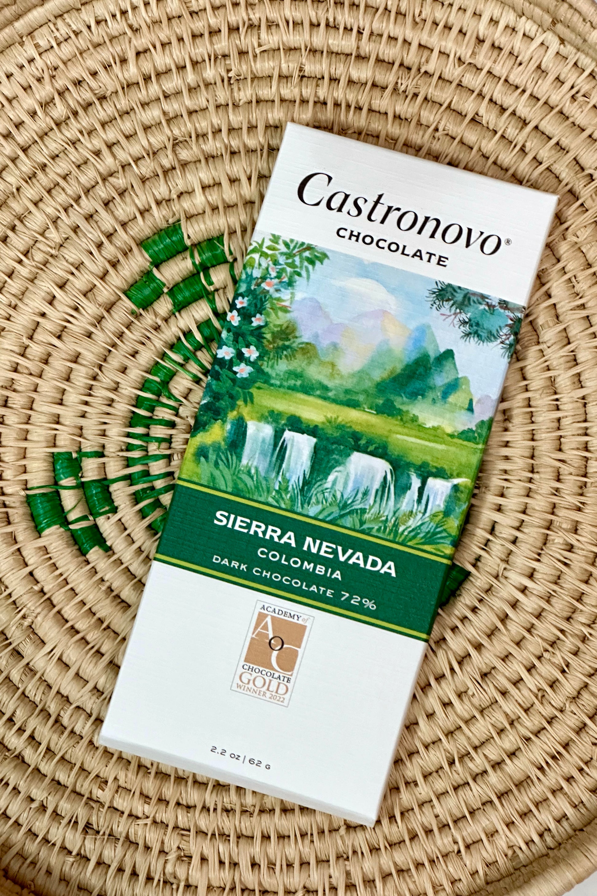 A bar of Castronovo Chocolate with a Sierra Nevada theme, featuring an illustration of a lush green landscape on the packaging.
