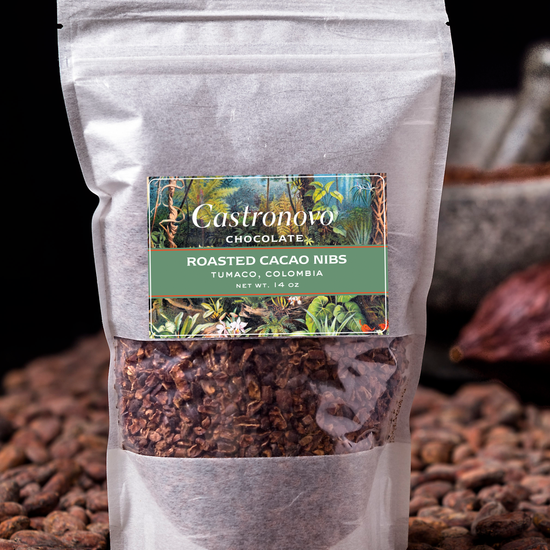 A package of Castronovo brand roasted cacao nibs placed on a surface with scattered cacao beans.