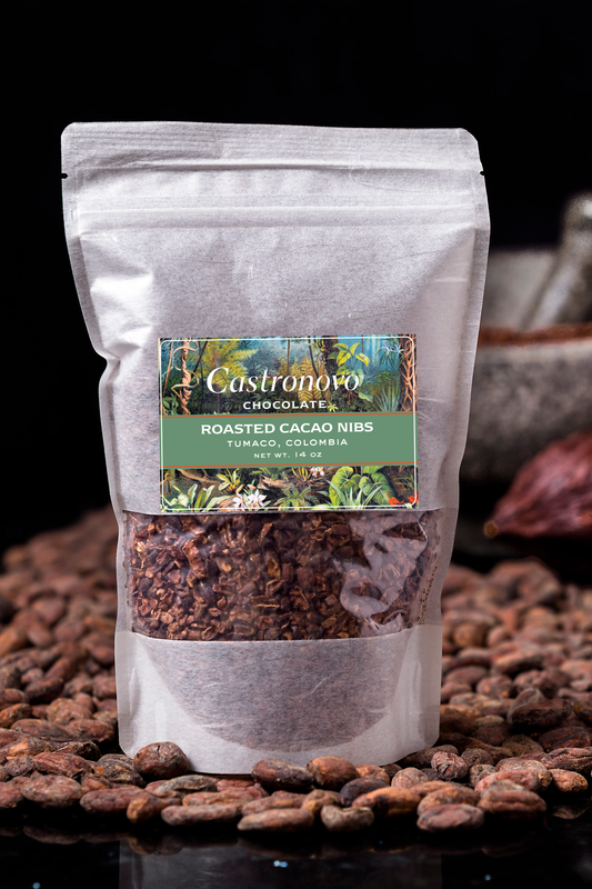 A package of Castronovo brand roasted cacao nibs placed on a surface with scattered cacao beans.