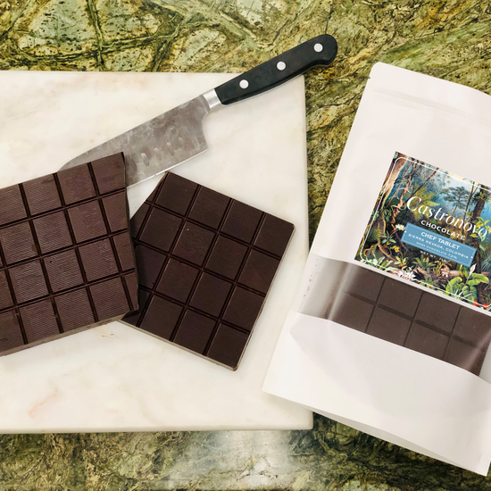 Photo of chocolate chef tablet for baking, with inside contents placed next to package on cutting board 