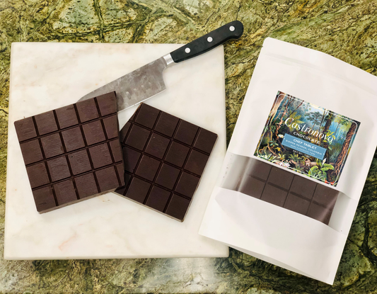 Photo of chocolate chef tablet for baking, with inside contents placed next to package on cutting board 