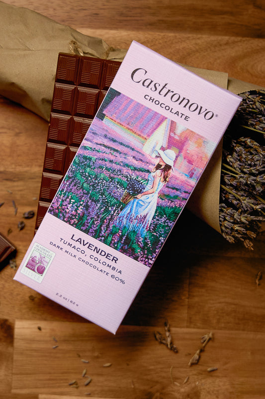 A chocolate bar packaging with an image of a woman in a field of lavender, alongside pieces of dark milk chocolate.