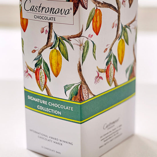 A box of Castronovo Chocolate Signature Collection Gift Set featuring an assortment of dark and milk chocolate bars with different percentages of cocoa.